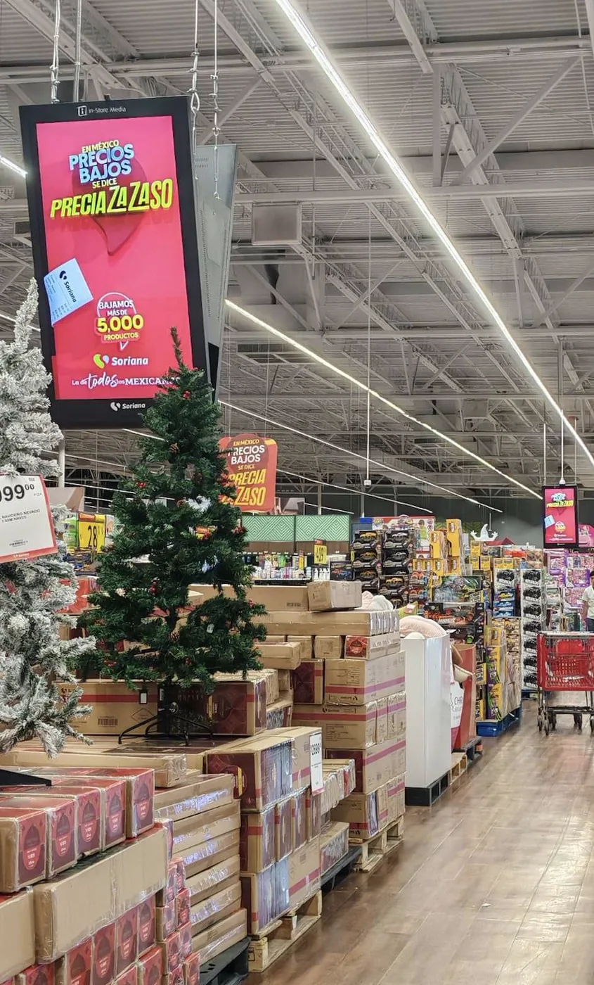 V-shaped hanging LCD screens promoting promotions across a supermarket aisle