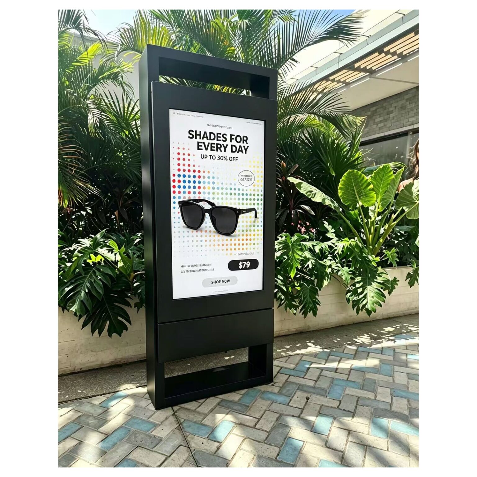 Outdoor standing totem display showing a sunglasses promotion on a paved walkway