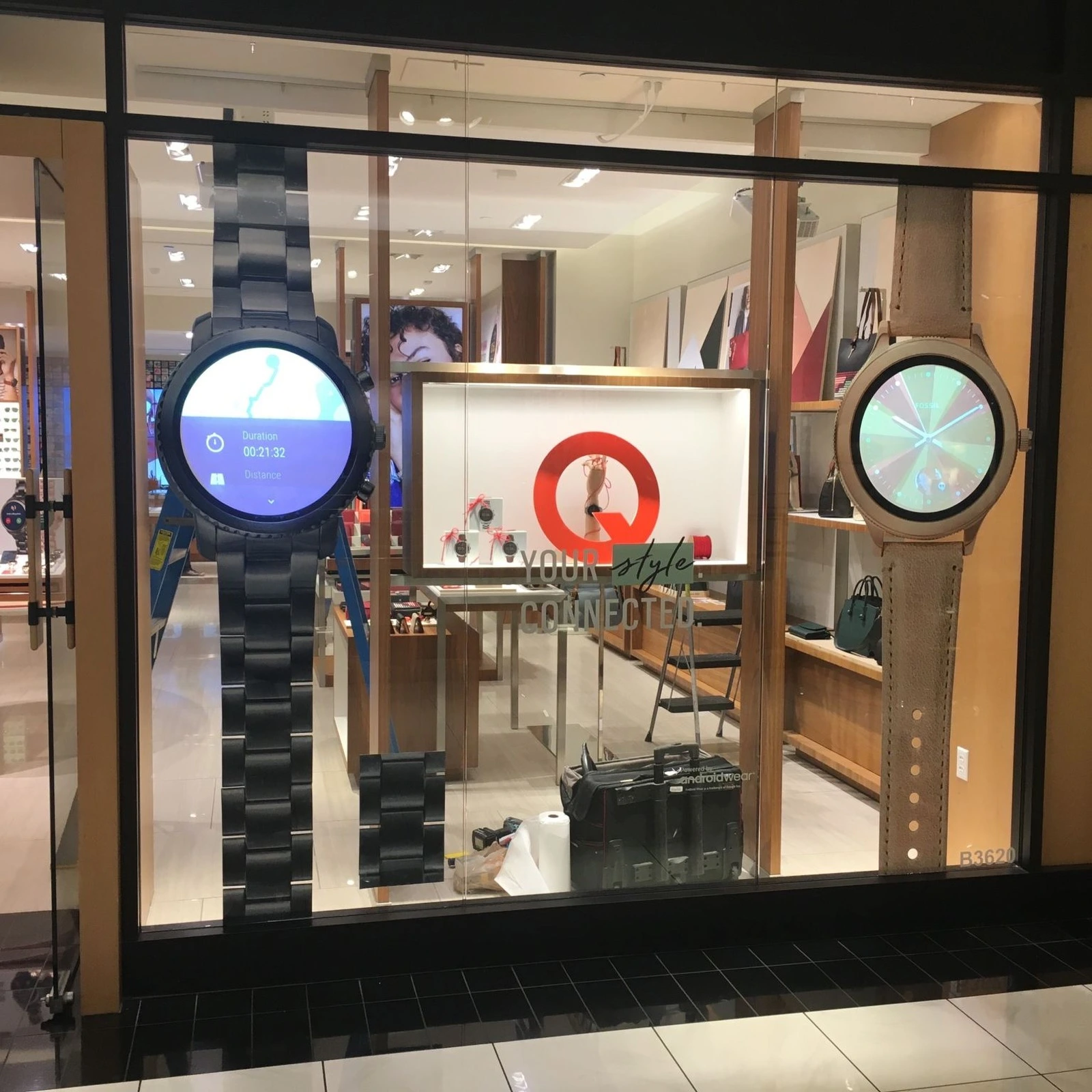 Oversized round LCD watches displayed in a Fossil retail window