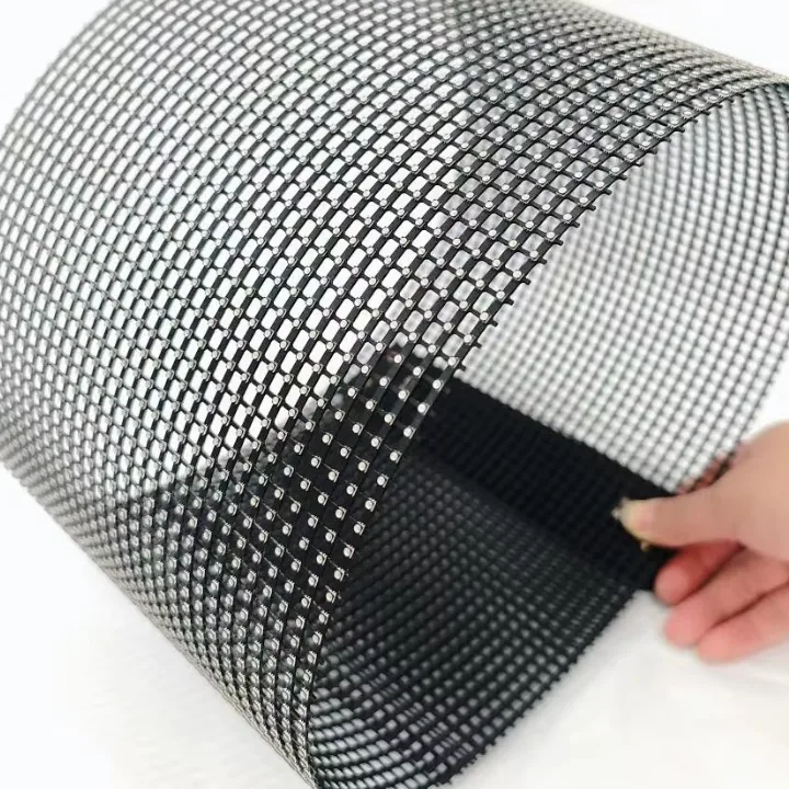Flexible transparent LED mesh film bent by hand, showing its see-through dot-matrix structure